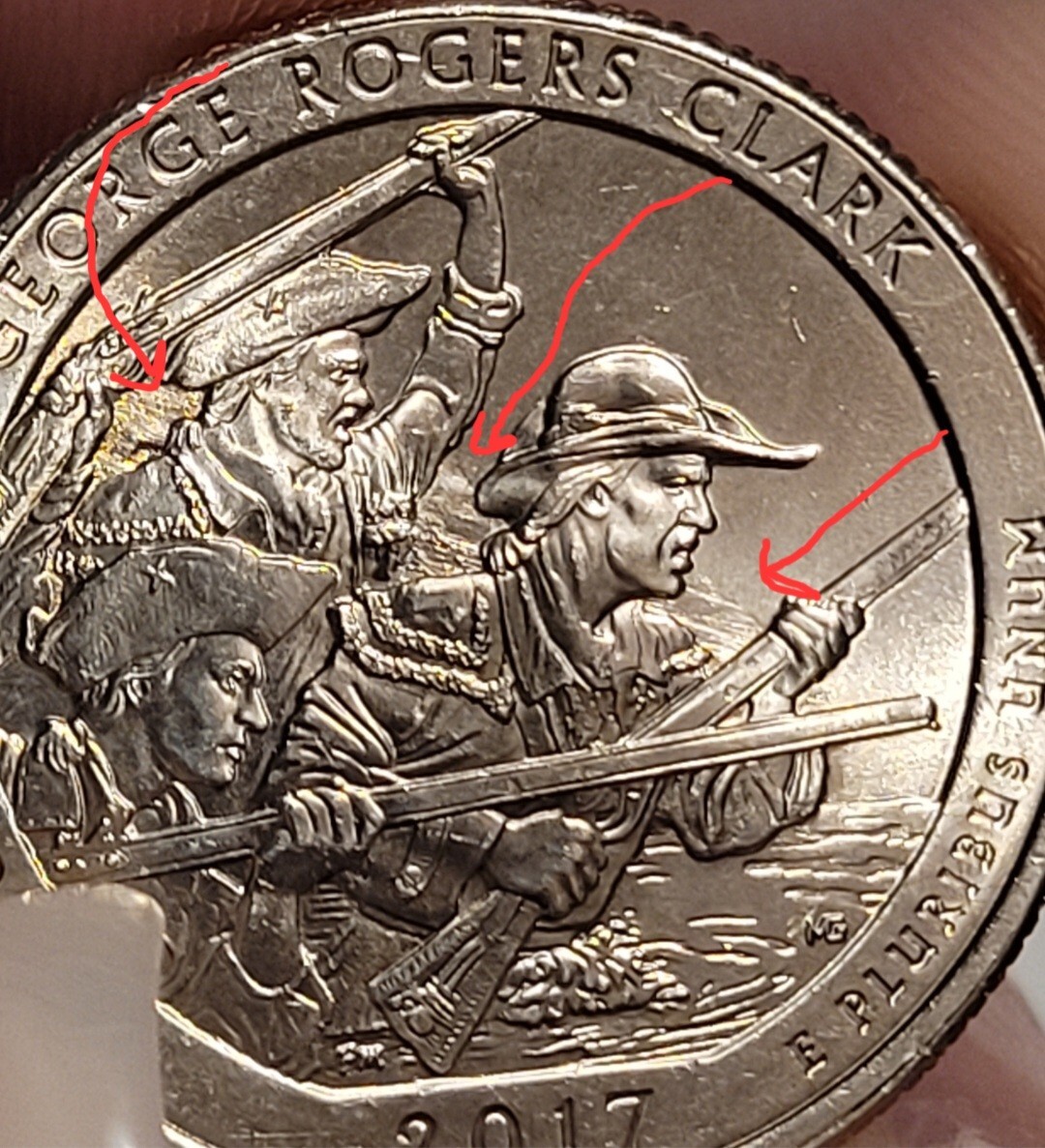2017 quarter struck-through error — recessed impression in design where foreign material was between die and planchet during striking